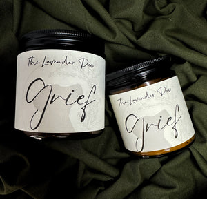 2 candles in different sizes for the Signature Collection on a green background