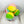 Squeaky ball dog toy wrapped in fabric to look like a beach ball. The toys are sitting on a light wood surface with a white background. 