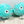 Two plush dog toys designed to resemble pufferfish with blue bodies and cartoon faces. 