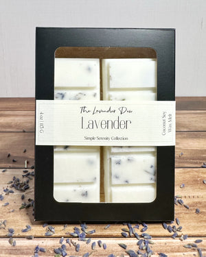 Lavender wax melt bars in a black box with lavender petals on a wooden surface