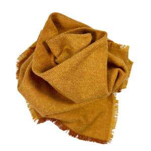 Flannel bandana with shades of orange sewn into a herringbone pattern.