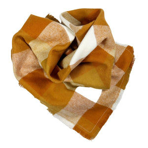 Plaid flannel bandana with colors of orange, red-orange, and white. 