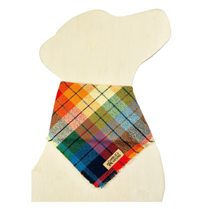 Colorful rainbow plaid bandana on a dog shaped wooden cutout with brand tag 'Charlie & the Hound'.