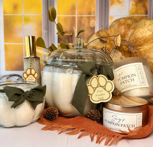 Decorative candles with paw print tags on a table with a warm, blurred background.