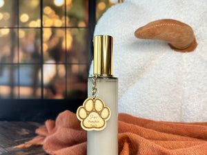 Room spray bottle with gold cap on a wooden surface with a blurred background