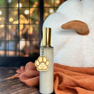 Room spray bottle with gold cap on a wooden surface with a blurred background