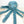Blue plush dog toy resembling an octopus with long tentacles. The toy sits on a light wooden surface with a white background. 