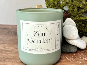 Scented candle labeled 'Zen Garden' on a wooden surface with decorative elements.