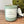 Scented candle labeled 'Zen Garden' on a wooden surface with decorative elements.