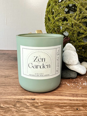Scented candle labeled 'Zen Garden' on a wooden surface with decorative elements.